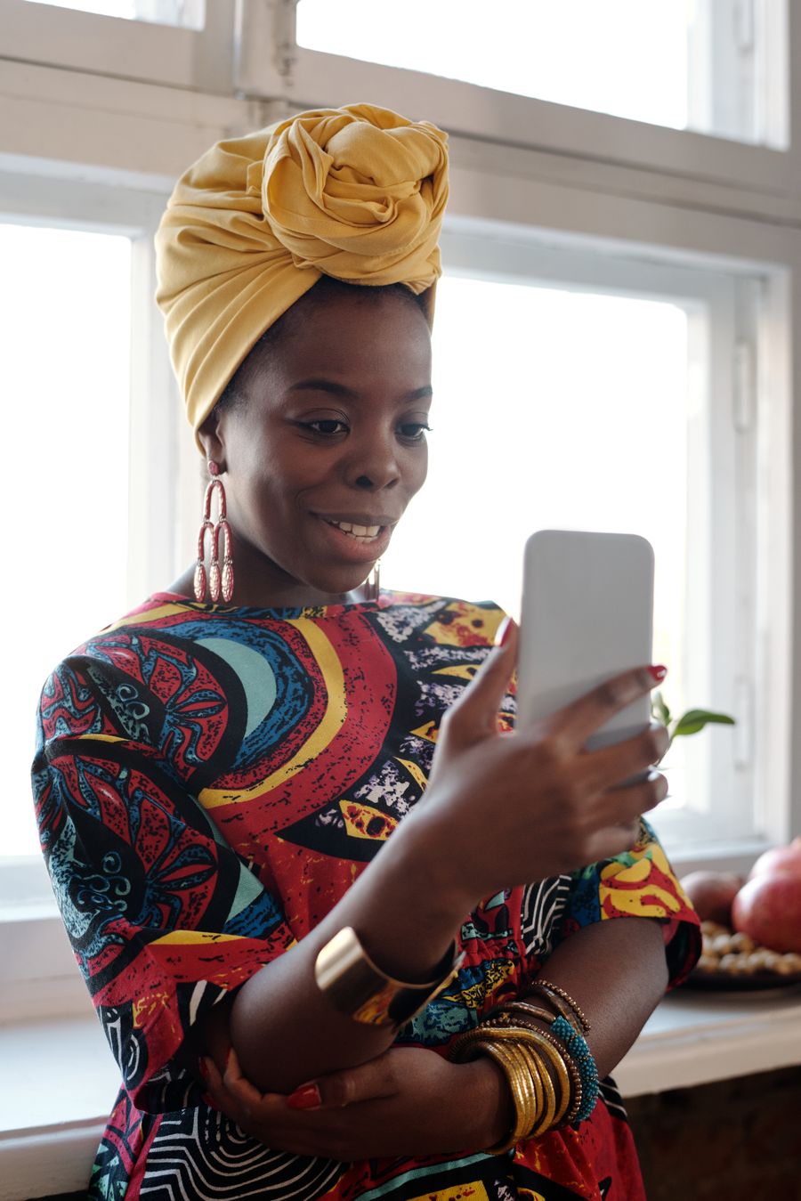 A woman smiling as she checks a payment on her phone